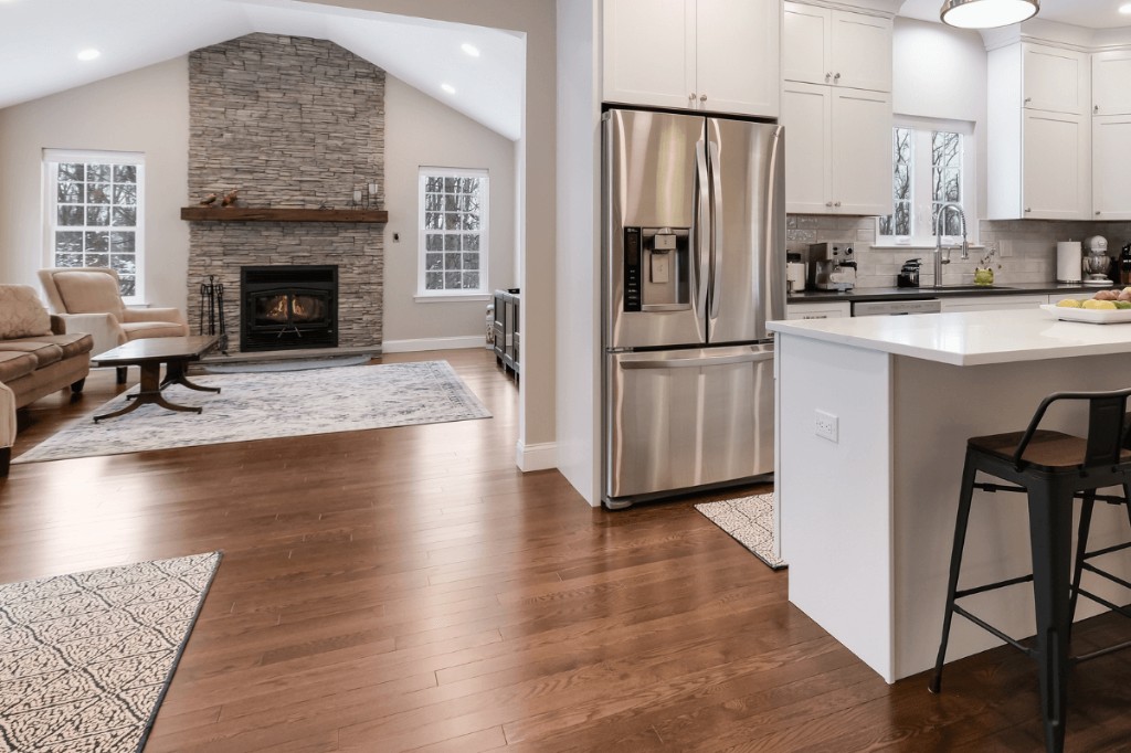 Open kitchen and living space with stone fireplace